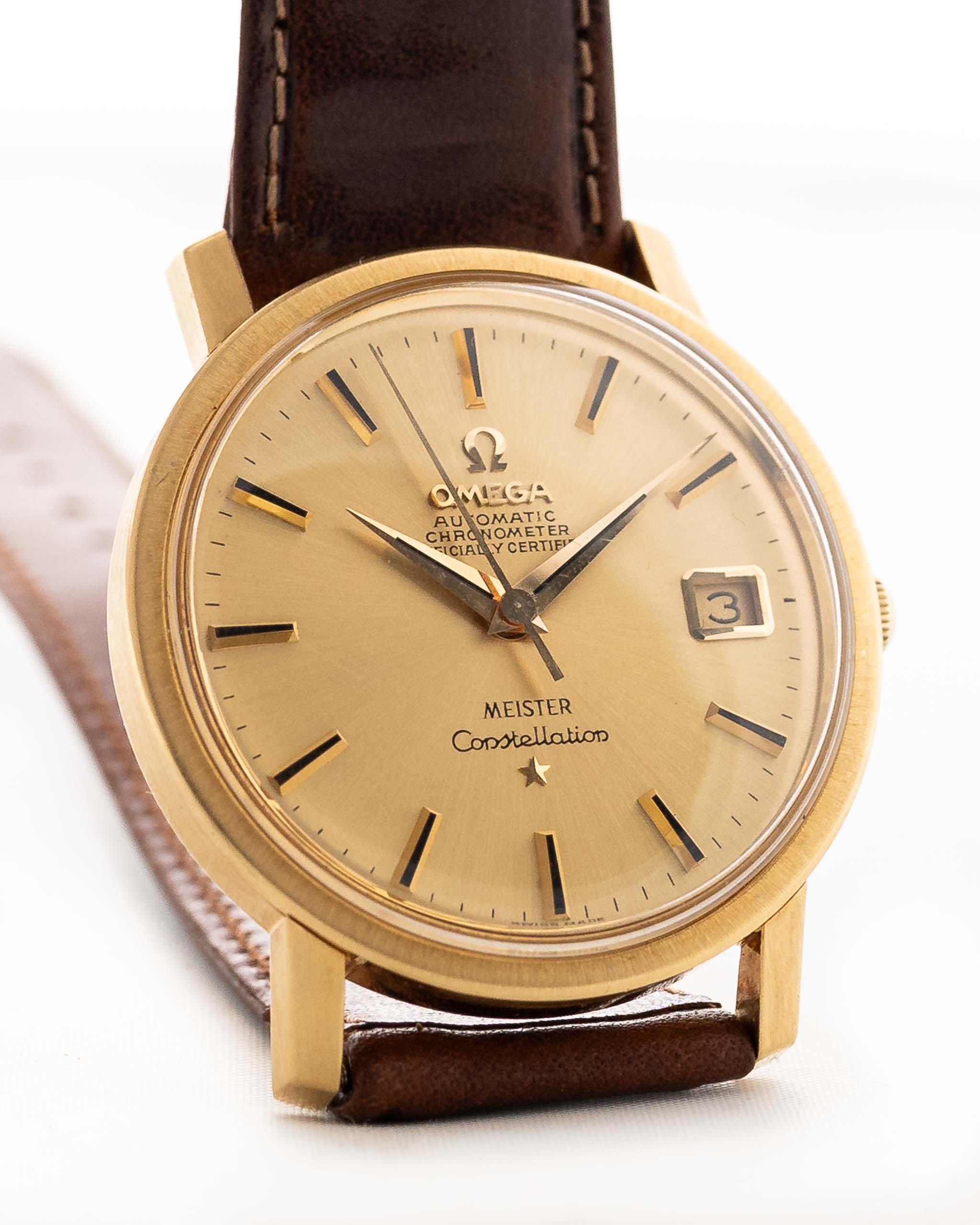 Omega Constellation 168018 Date "Meister" 1967, with 35mm 18k yellow gold case, sunburst dial, and rare double-signed design closeup
