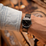 Vintage Omega watch Gilt Syringe from 1939, 33mm stainless steel case, black gilt dial, manual wind movement, black leather strap on wrist