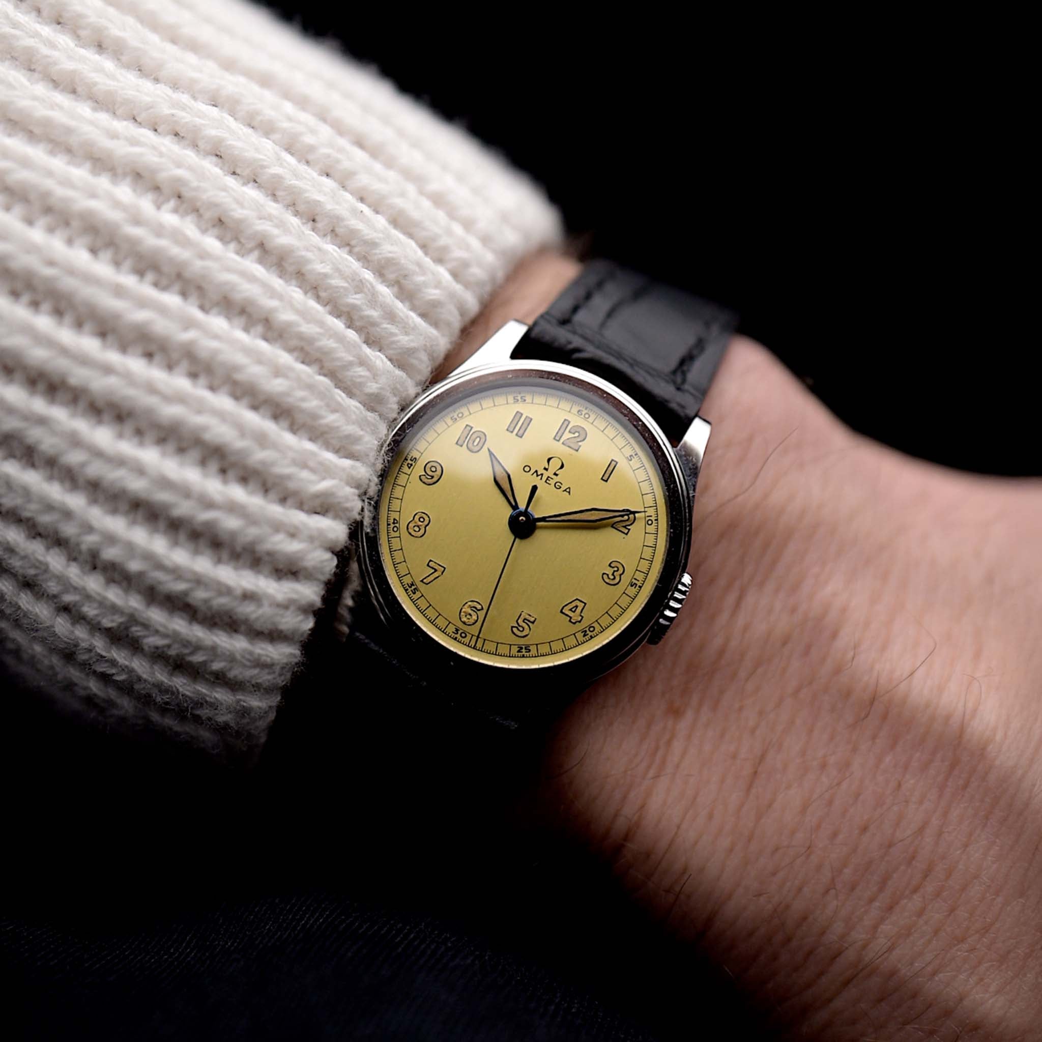 Photo of a Omega Radium Sword Arabic  from 1935 on a wrist. 28mm case in Stainless Steel with Manual wind movement, Original golden dial, Radium lume and Leather strap.