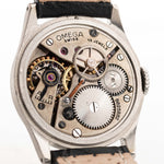 Closeup Photo of a Omega Radium Sword Arabic  from 1935 on a wrist. 28mm case in Stainless Steel with Manual wind movement, Original golden dial, Radium lume and Leather strap.