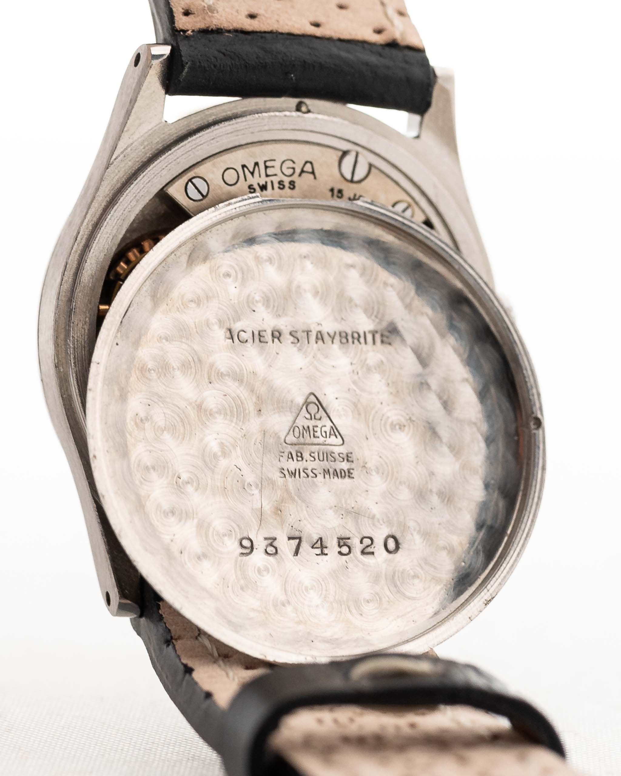 Closeup Photo of a Omega Radium Sword Arabic  from 1935 on a wrist. 28mm case in Stainless Steel with Manual wind movement, Original golden dial, Radium lume and Leather strap.