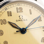 Closeup Photo of a Omega Radium Sword Arabic  from 1935 on a wrist. 28mm case in Stainless Steel with Manual wind movement, Original golden dial, Radium lume and Leather strap.