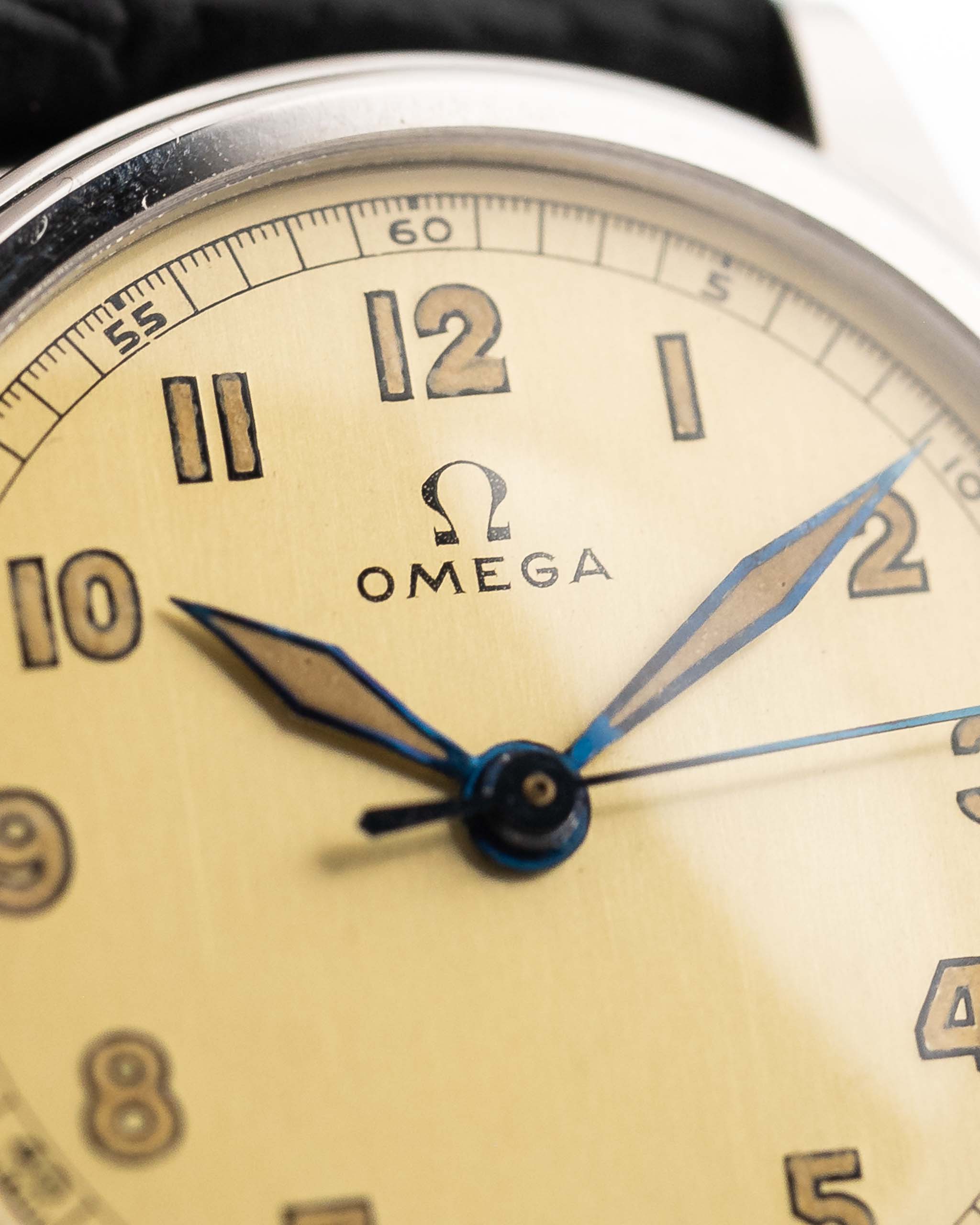 Closeup Photo of a Omega Radium Sword Arabic  from 1935 on a wrist. 28mm case in Stainless Steel with Manual wind movement, Original golden dial, Radium lume and Leather strap.
