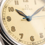Closeup Photo of a Omega Radium Sword Arabic  from 1935 on a wrist. 28mm case in Stainless Steel with Manual wind movement, Original golden dial, Radium lume and Leather strap.