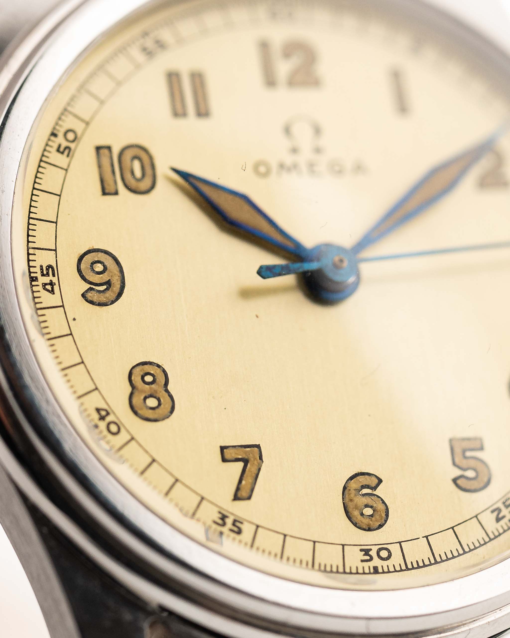 Closeup Photo of a Omega Radium Sword Arabic  from 1935 on a wrist. 28mm case in Stainless Steel with Manual wind movement, Original golden dial, Radium lume and Leather strap.