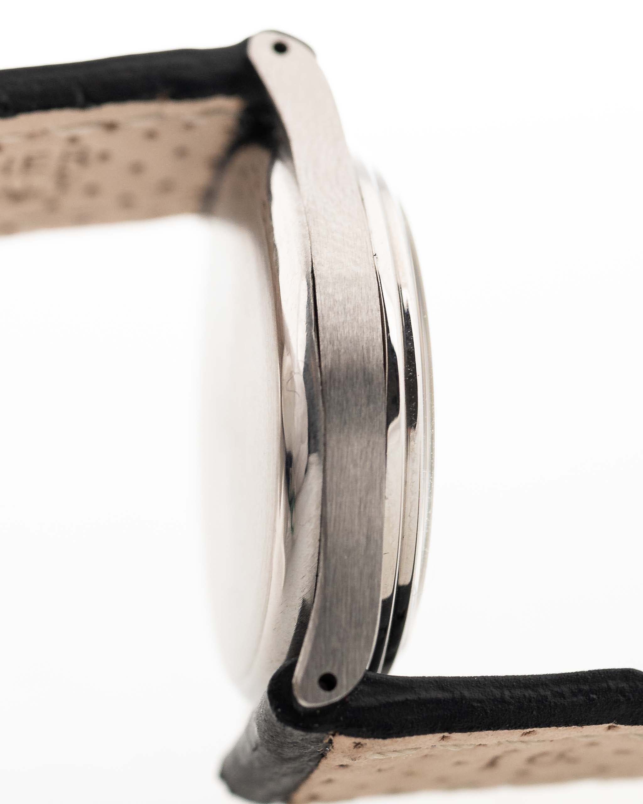 Closeup Photo of a Omega Radium Sword Arabic  from 1935 on a wrist. 28mm case in Stainless Steel with Manual wind movement, Original golden dial, Radium lume and Leather strap.