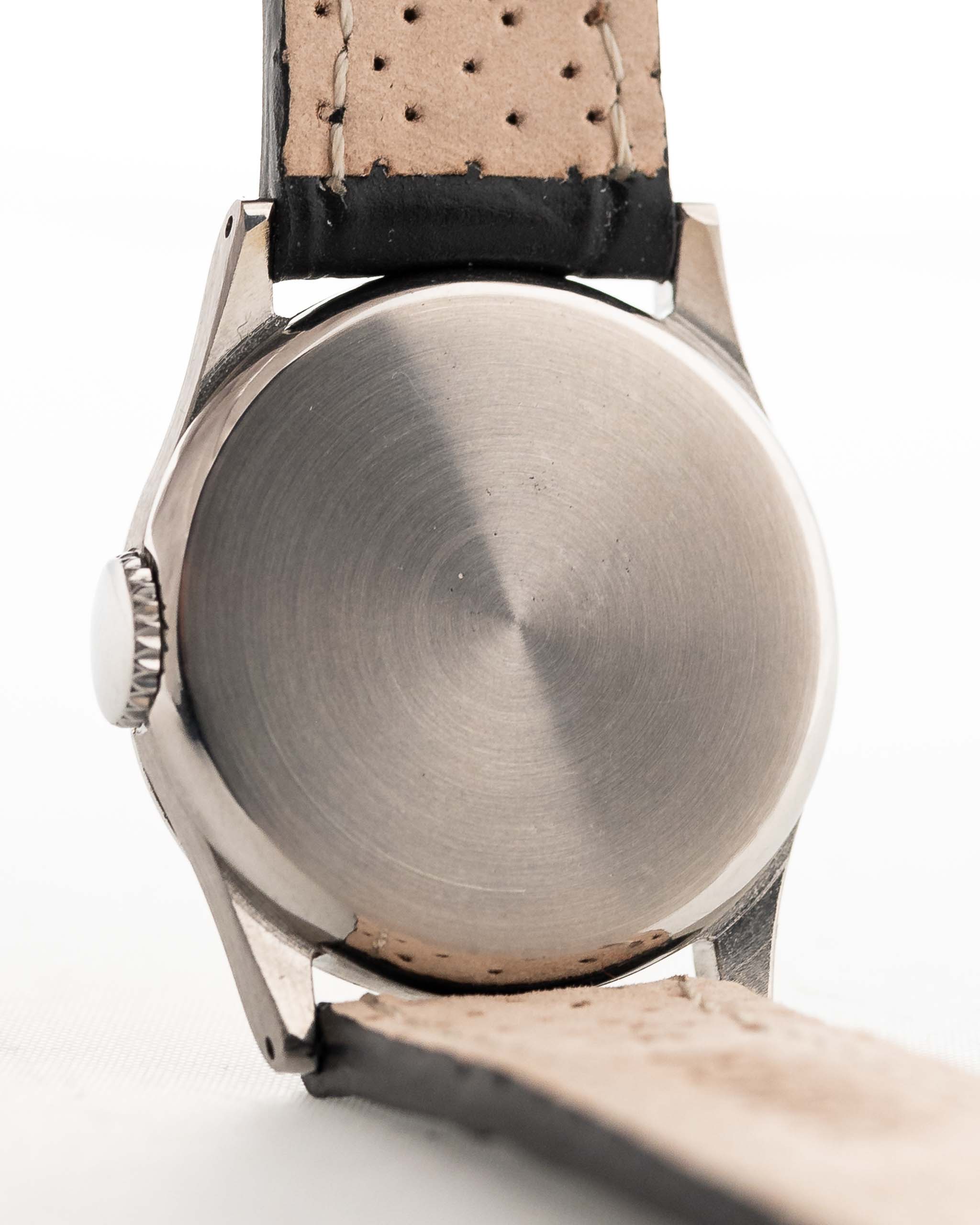 Closeup Photo of a Omega Radium Sword Arabic  from 1935 on a wrist. 28mm case in Stainless Steel with Manual wind movement, Original golden dial, Radium lume and Leather strap.