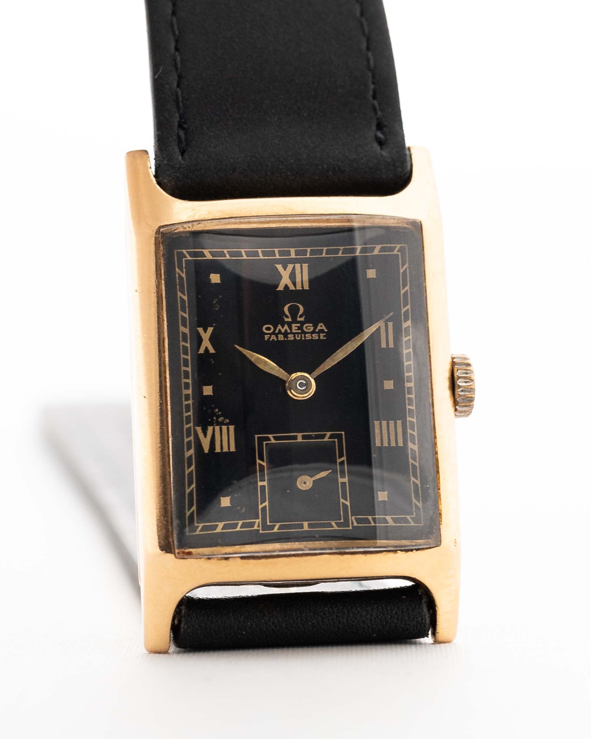 Vintage Omega Tank Gilt watch Roman from 1944. 18mm wide with 18k Rose Gold Case, Manual Wind Movement, Black Gilt Dial, Roman Numerals and Black Leather Strap.