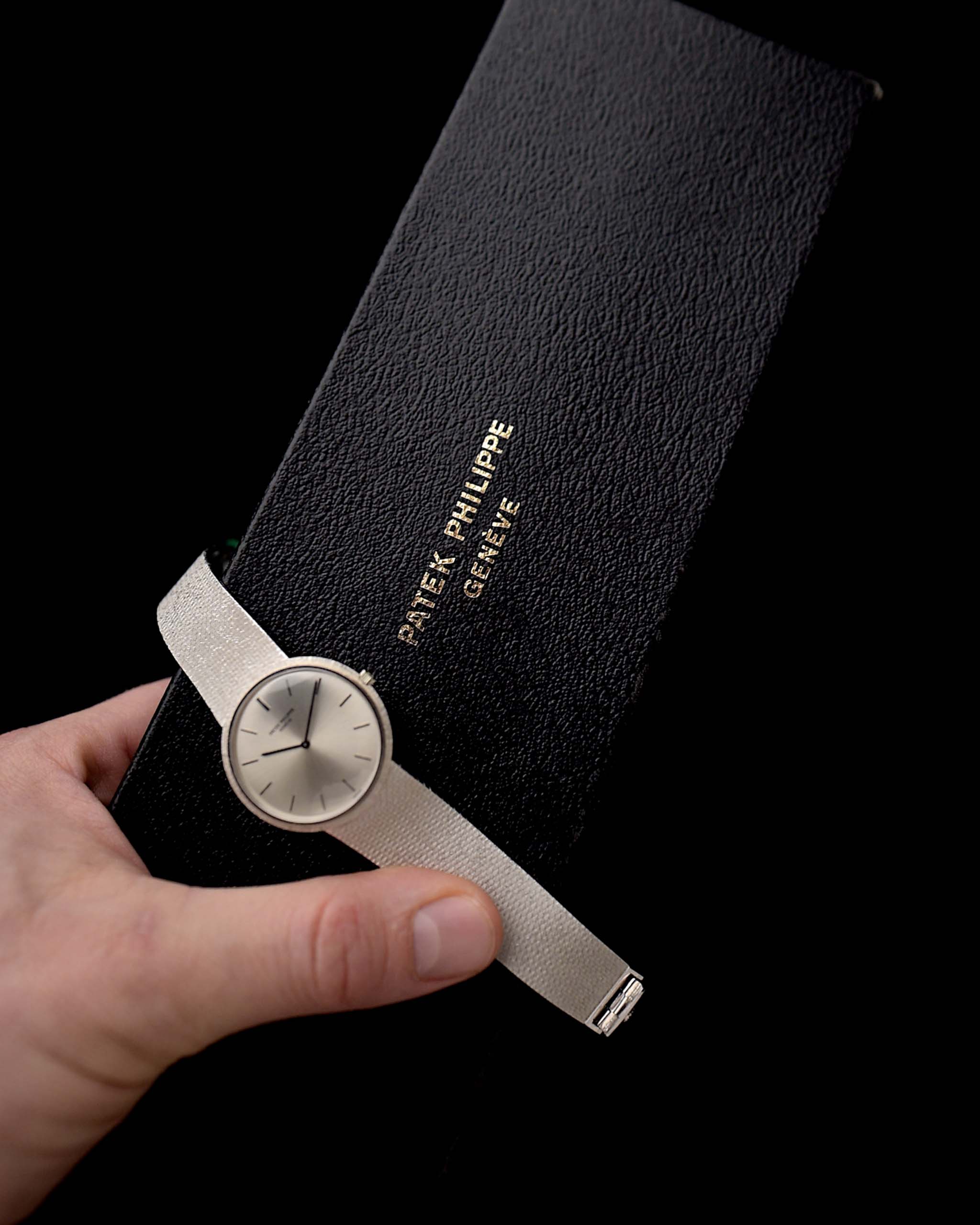 Closeup Photo of a Patek Philippe 3520 Calatrava 18k from the 1970s with Box. 32mm 18k White Gold Case with Manual Wind Movement, Original Silver Sunburst Dial and White Gold Bracelet.