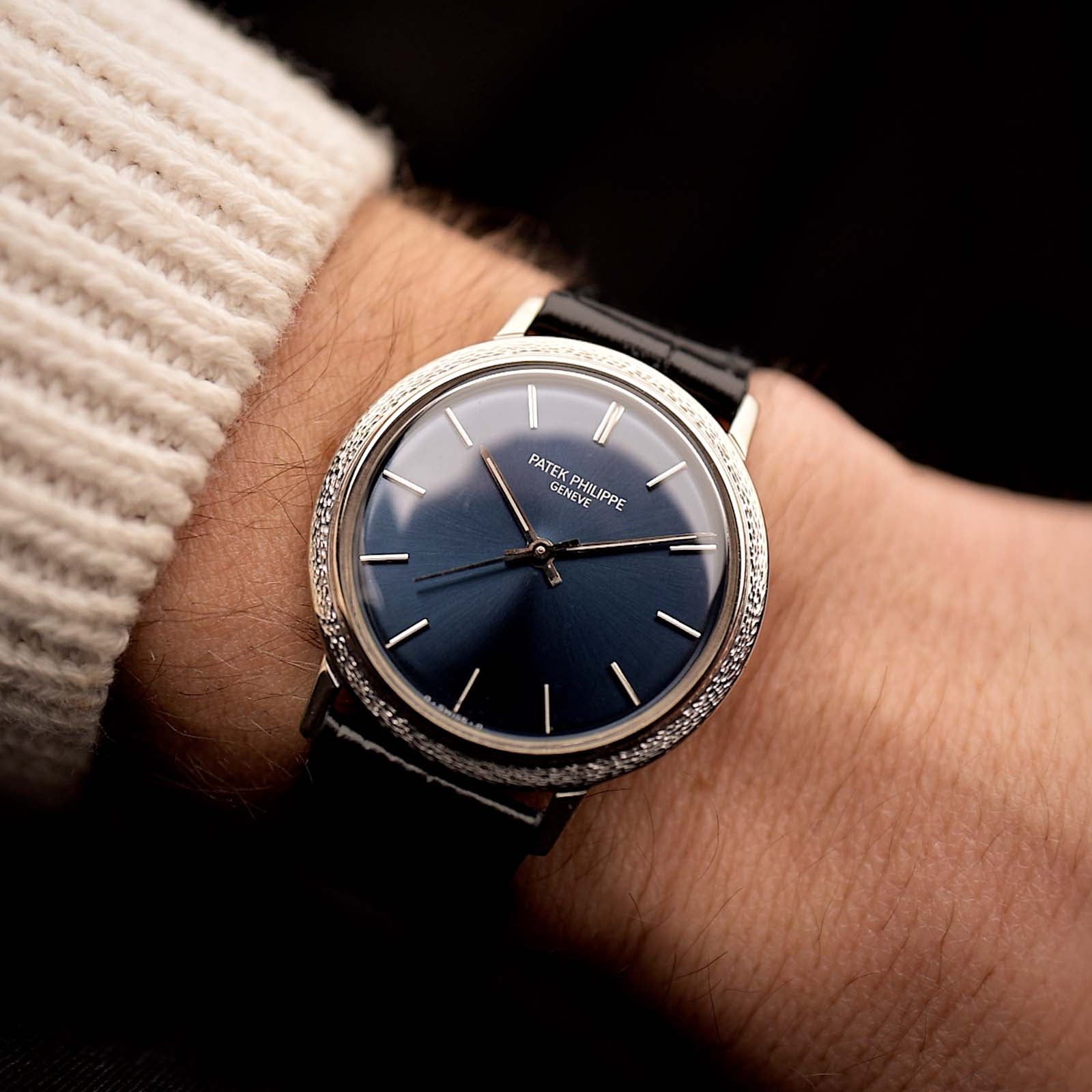 Patek Philippe Calatrava Ref 3569 Vintage watch from 1980s, 18k white gold, blue sigma dial, automatic movement on a wrist on black background