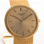 Patek Philippe Calatrava yellow gold 3520 1970 - patek philippe watch - 18k yellow gold case - golden colored sunburst dial - integrated 18k yellow gold bracelet closeup