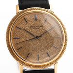 Closeup Photo of a Patek Philippe Calatrava 3569 Hammered 1970 on a wrist. 36mm case in 18k Yellow Gold Case wth Hammered Gold Dial, Automatic Movement and Original Leather Strap.