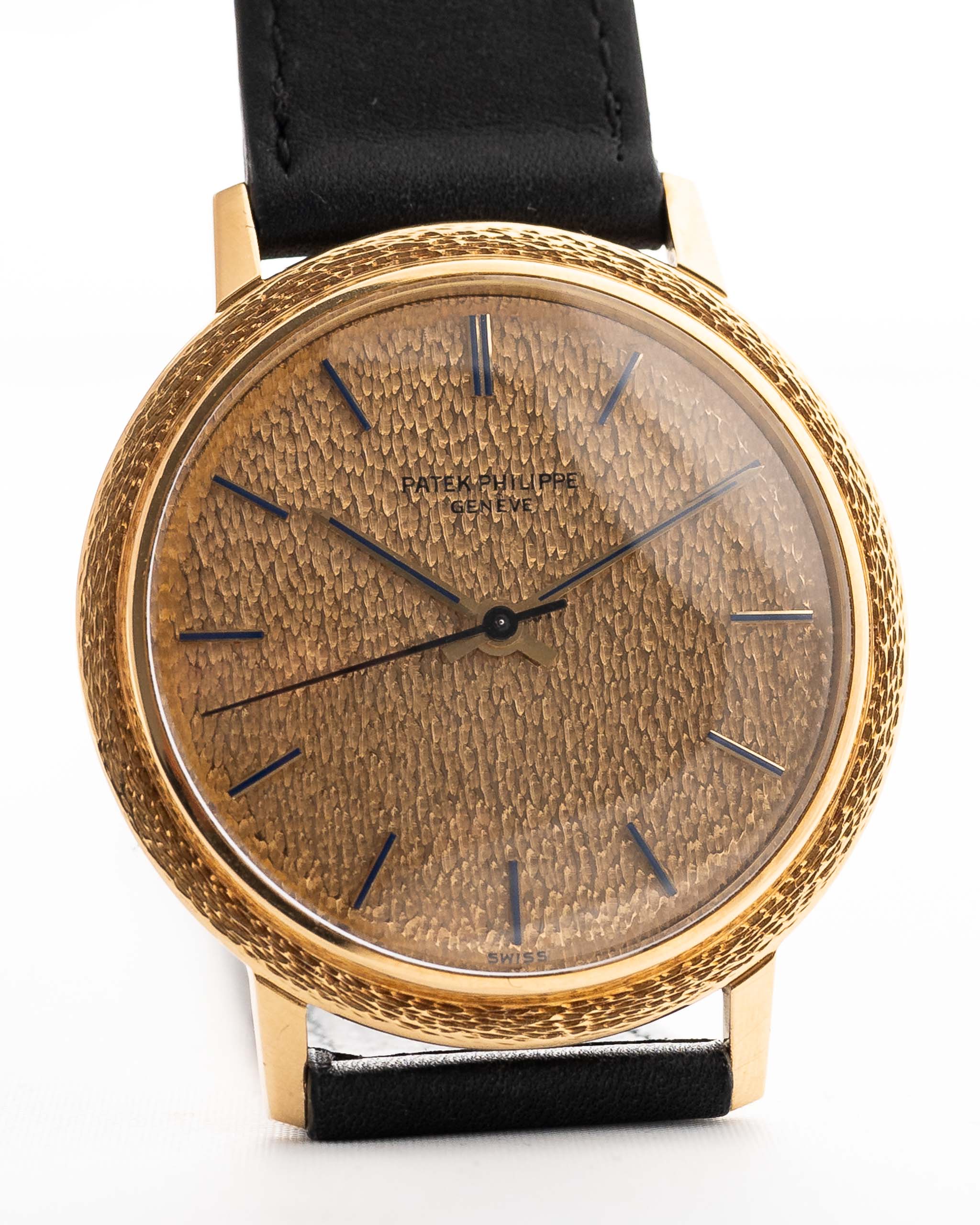 Closeup Photo of a Patek Philippe Calatrava 3569 Hammered 1970 on a wrist. 36mm case in 18k Yellow Gold Case wth Hammered Gold Dial, Automatic Movement and Original Leather Strap.