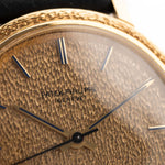 Closeup Photo of a Patek Philippe Calatrava 3569 Hammered 1970 on a wrist. 36mm case in 18k Yellow Gold Case wth Hammered Gold Dial, Automatic Movement and Original Leather Strap.
