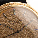 Closeup Photo of a Patek Philippe Calatrava 3569 Hammered 1970 on a wrist. 36mm case in 18k Yellow Gold Case wth Hammered Gold Dial, Automatic Movement and Original Leather Strap.