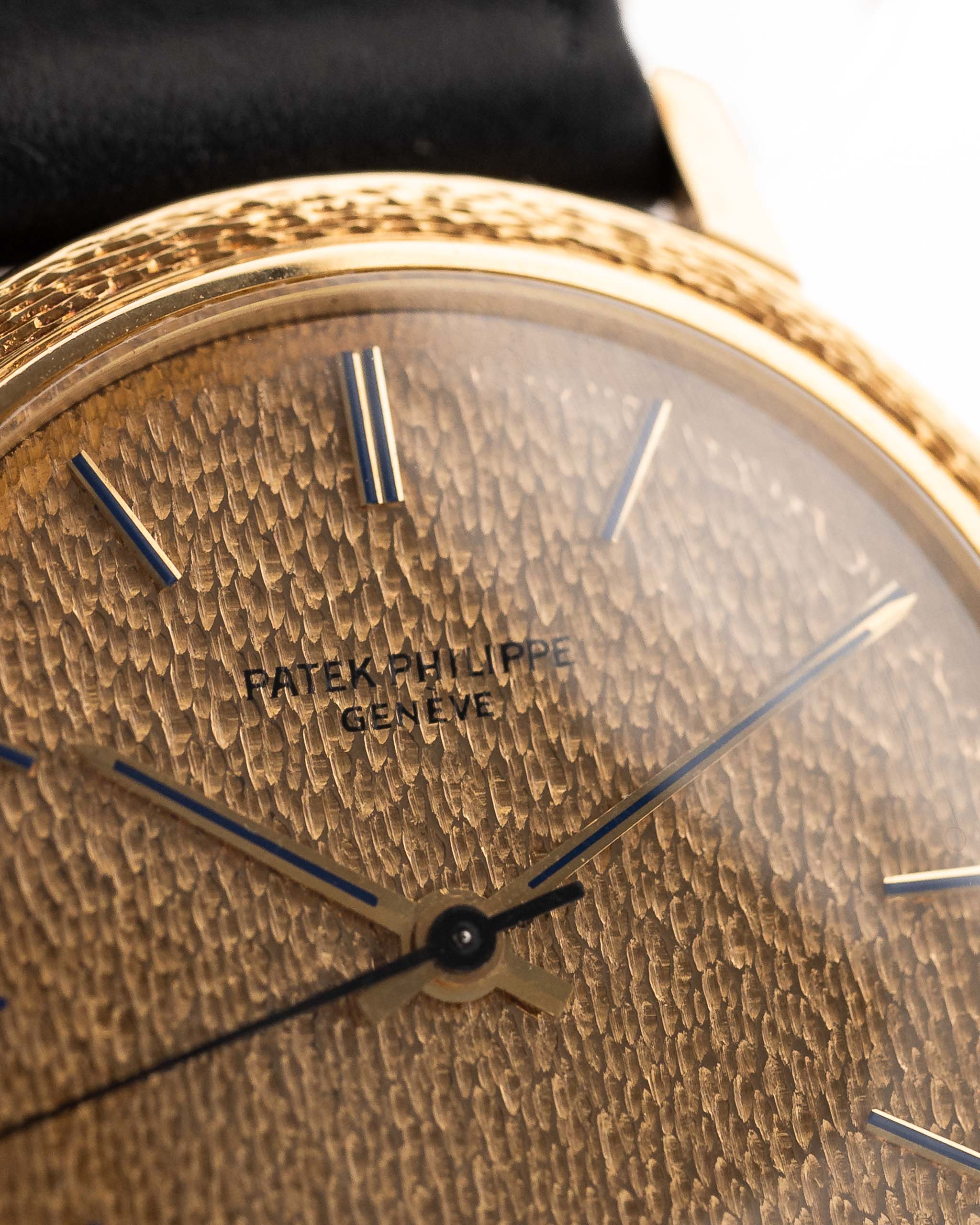 Closeup Photo of a Patek Philippe Calatrava 3569 Hammered 1970 on a wrist. 36mm case in 18k Yellow Gold Case wth Hammered Gold Dial, Automatic Movement and Original Leather Strap.