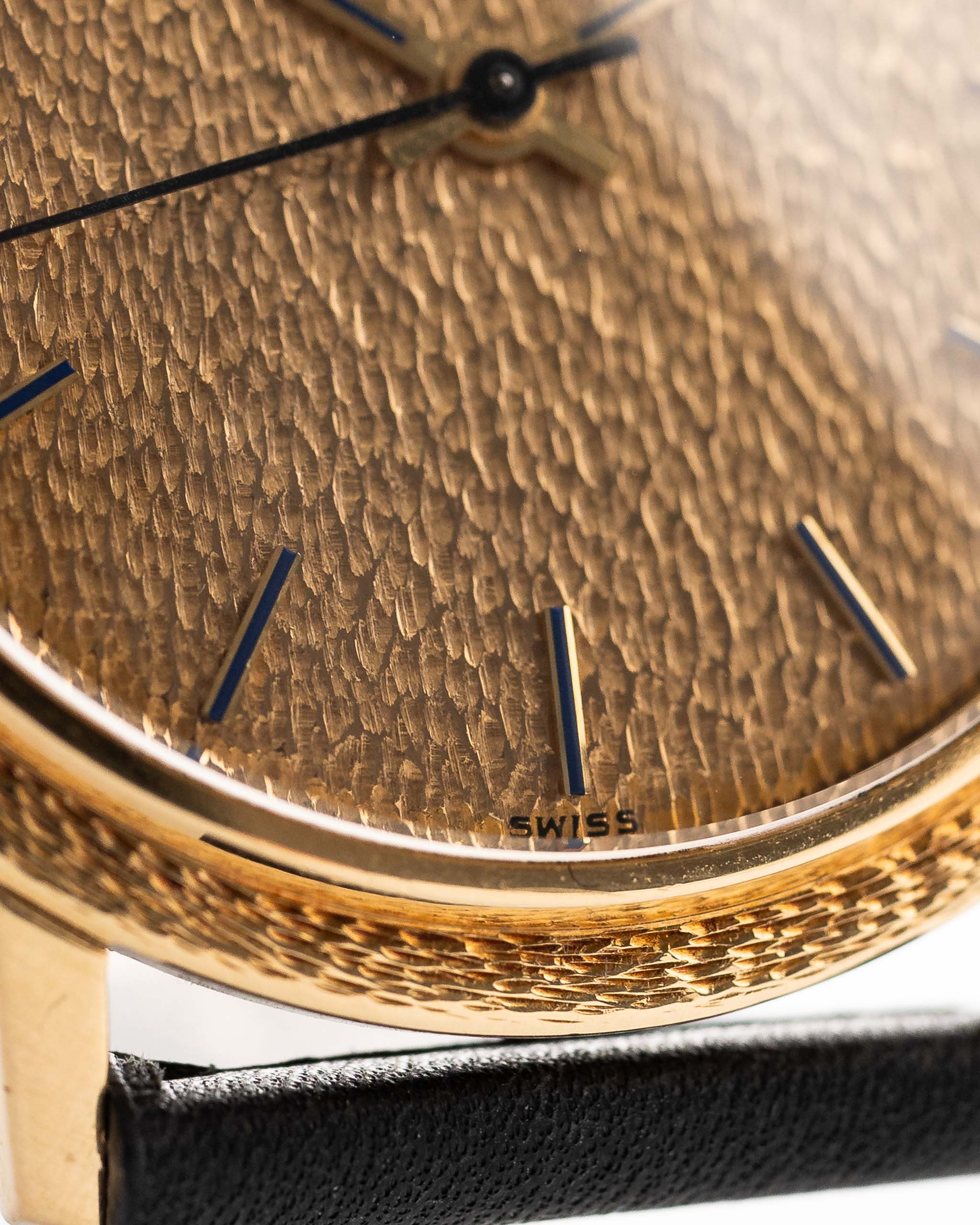 Closeup Photo of a Patek Philippe Calatrava 3569 Hammered 1970 on a wrist. 36mm case in 18k Yellow Gold Case wth Hammered Gold Dial, Automatic Movement and Original Leather Strap.
