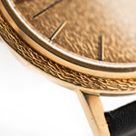 Closeup Photo of a Patek Philippe Calatrava 3569 Hammered 1970 on a wrist. 36mm case in 18k Yellow Gold Case wth Hammered Gold Dial, Automatic Movement and Original Leather Strap.