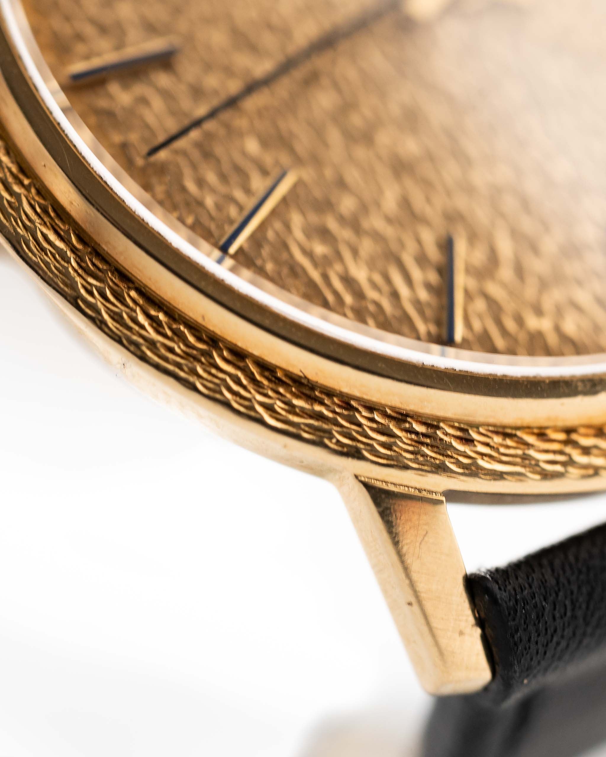 Closeup Photo of a Patek Philippe Calatrava 3569 Hammered 1970 on a wrist. 36mm case in 18k Yellow Gold Case wth Hammered Gold Dial, Automatic Movement and Original Leather Strap.