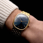 Photo of a Patek Philippe Ellipse 3738 Jumbo from 1998 on wrist. With Automatic  movement, 31mm case, 27 jewels, original blue sunburst dial, Yellow gold bracelet.