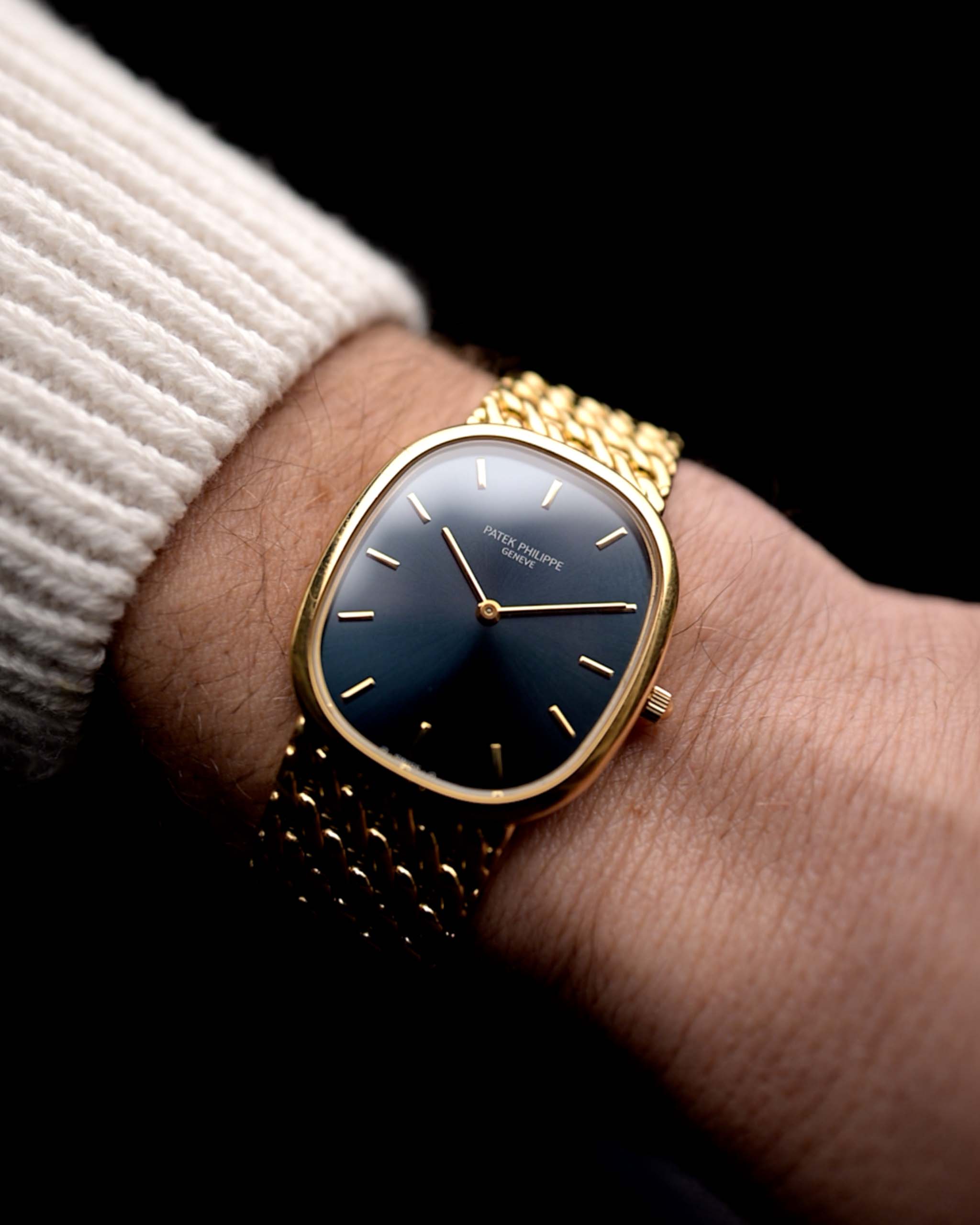 Photo of a Patek Philippe Ellipse 3738 Jumbo from 1998 on wrist. With Automatic  movement, 31mm case, 27 jewels, original blue sunburst dial, Yellow gold bracelet.