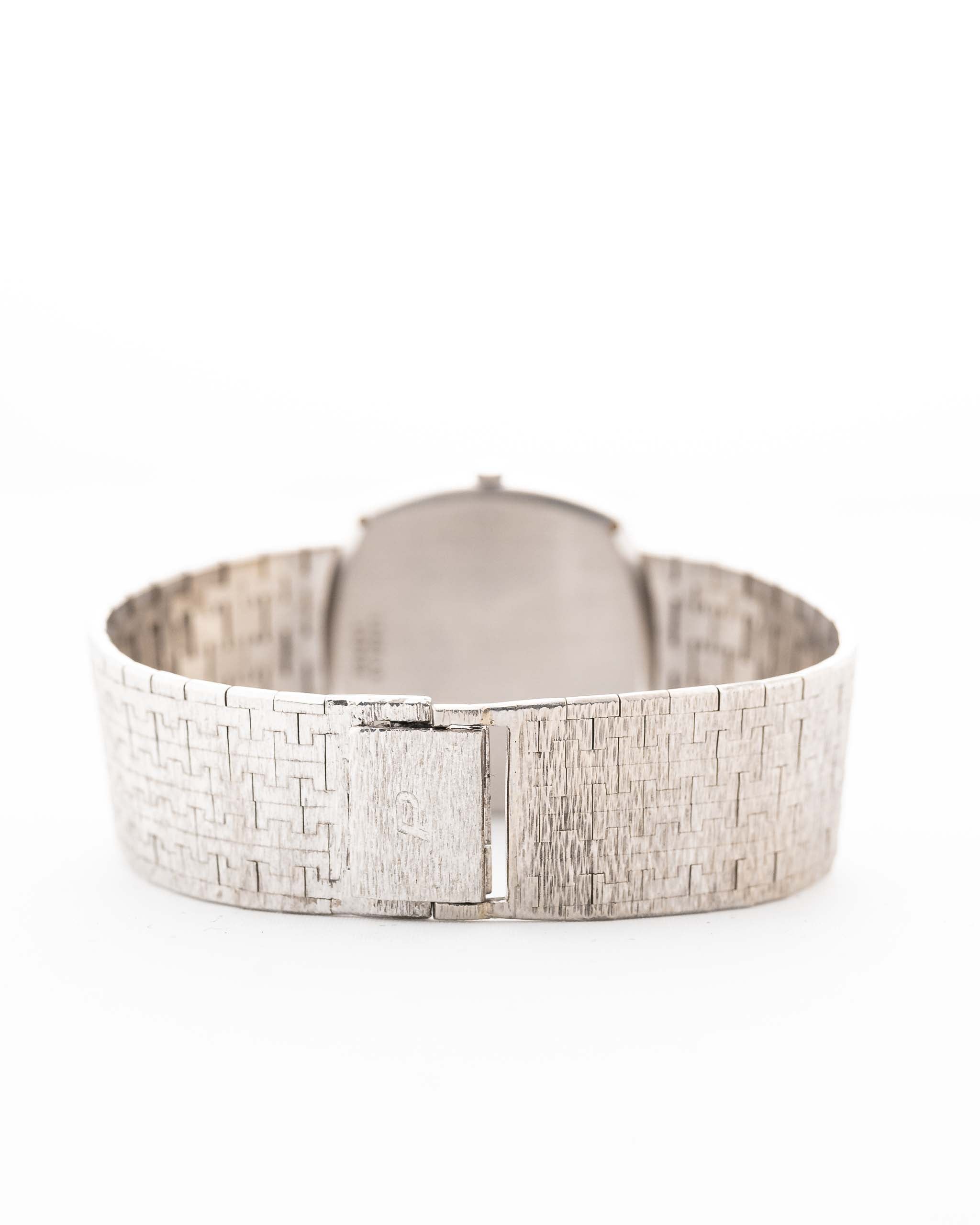Photo of a Piaget 12401 Automatic 18k TV Bark from the 1970s on a wrist. 32.5mm with 18k White Gold Case, Automatic Movement, White Gold Hammered Dial and Integrated 18k.