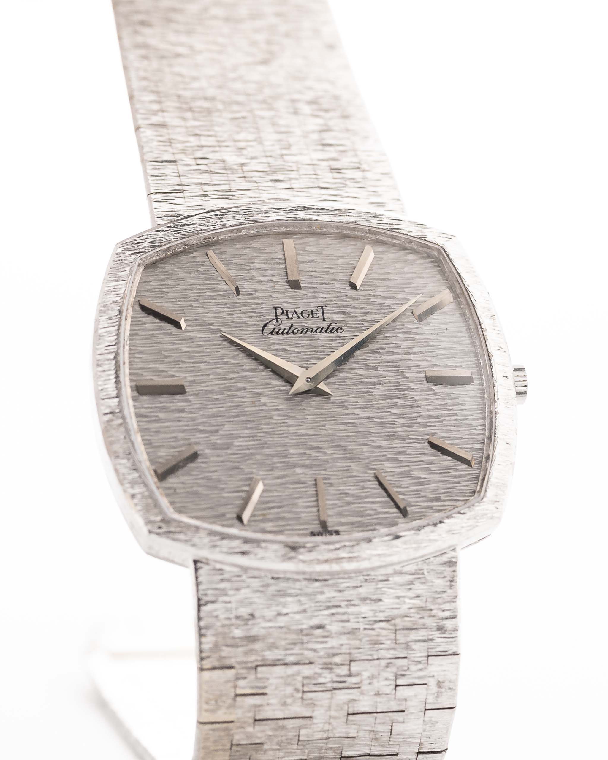Closeup Photo of a Piaget 12401 Automatic 18k TV Bark from the 1970s on a wrist. 32.5mm with 18k White Gold Case, Automatic Movement, White Gold Hammered Dial and Integrated 18k.