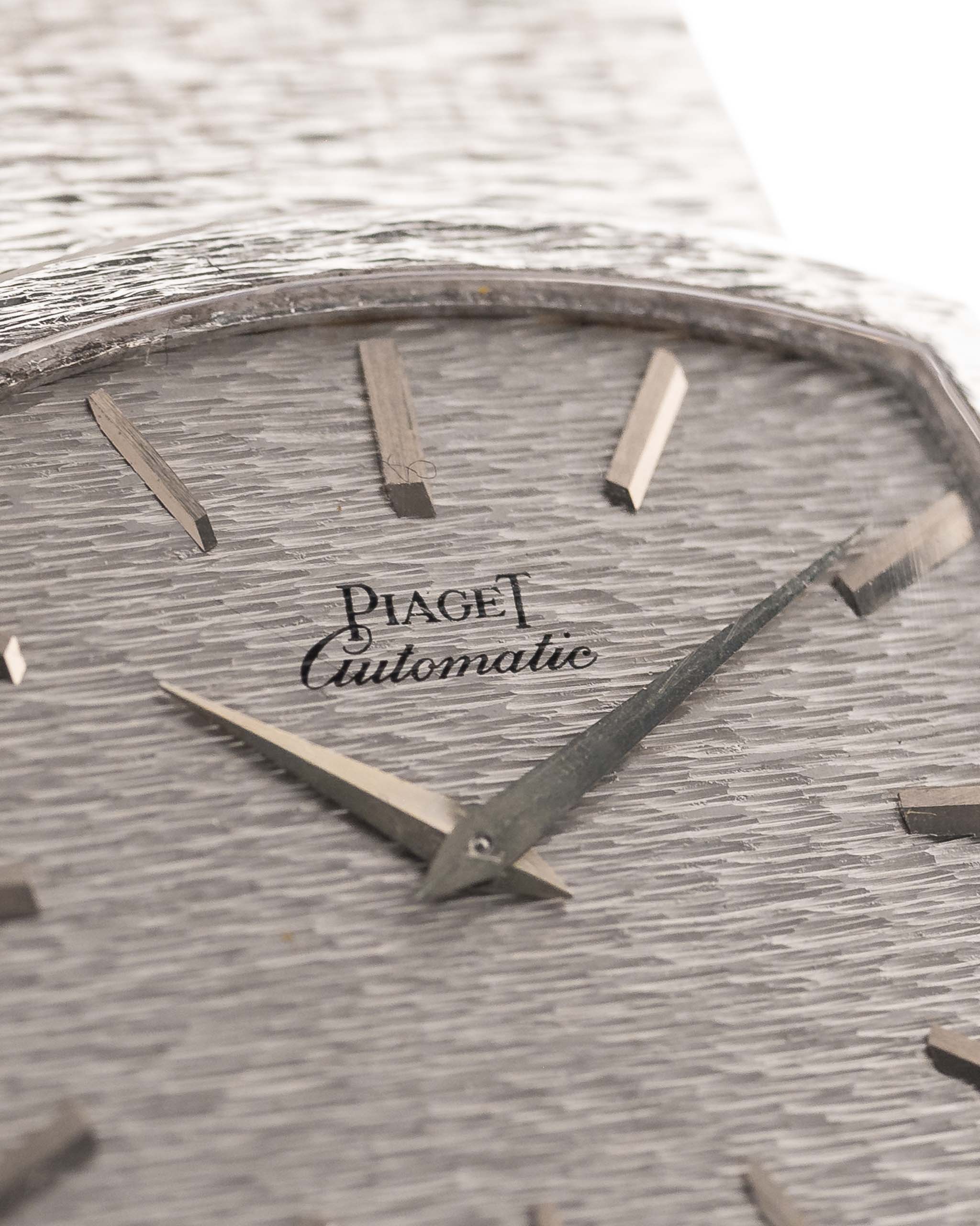 Closeup Photo of a Piaget 12401 Automatic 18k TV Bark from the 1970s on a wrist. 32.5mm with 18k White Gold Case, Automatic Movement, White Gold Hammered Dial and Integrated 18k.