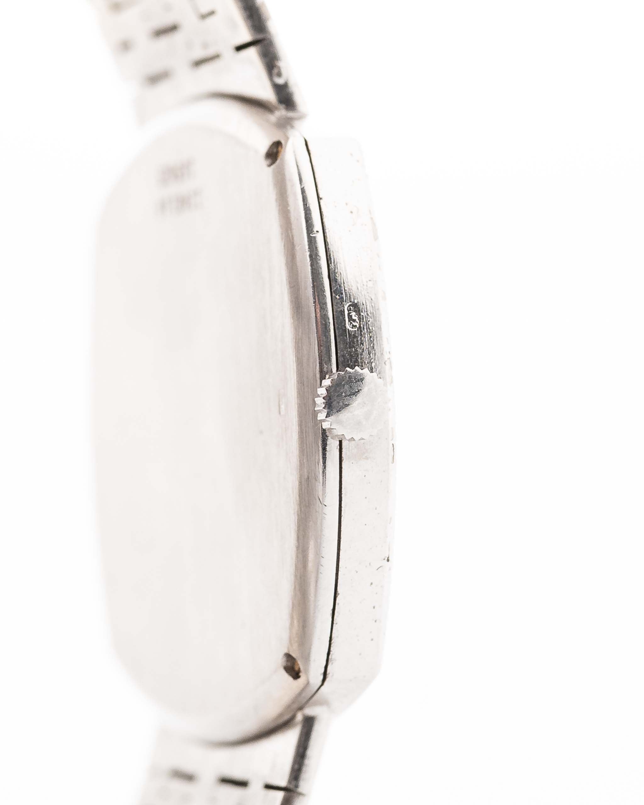 Closeup Photo of a Piaget 12401 Automatic 18k TV Bark from the 1970s on a wrist. 32.5mm with 18k White Gold Case, Automatic Movement, White Gold Hammered Dial and Integrated 18k.
