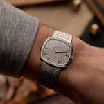 Vintage Piaget TV 12401 Bark watch Vintage Watch 18k white gold TV case white hammered dial Cal 12P1 on integrated bracelet on blurred background