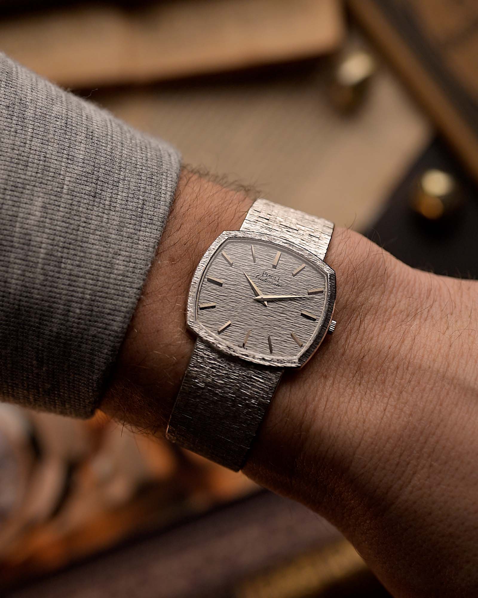 Vintage Piaget TV 12401 Bark watch Vintage Watch 18k white gold TV case white hammered dial Cal 12P1 on integrated bracelet on blurred background