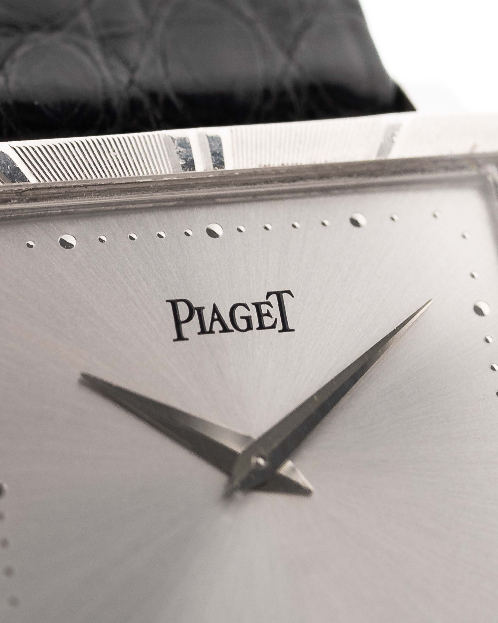 Closeup Photo of a Piaget Protocole 927 18k White Gold from the 1970s. 25mm in 18k White Gold with Manual wind movement, Silver sunburst dial and Original black leather strap.