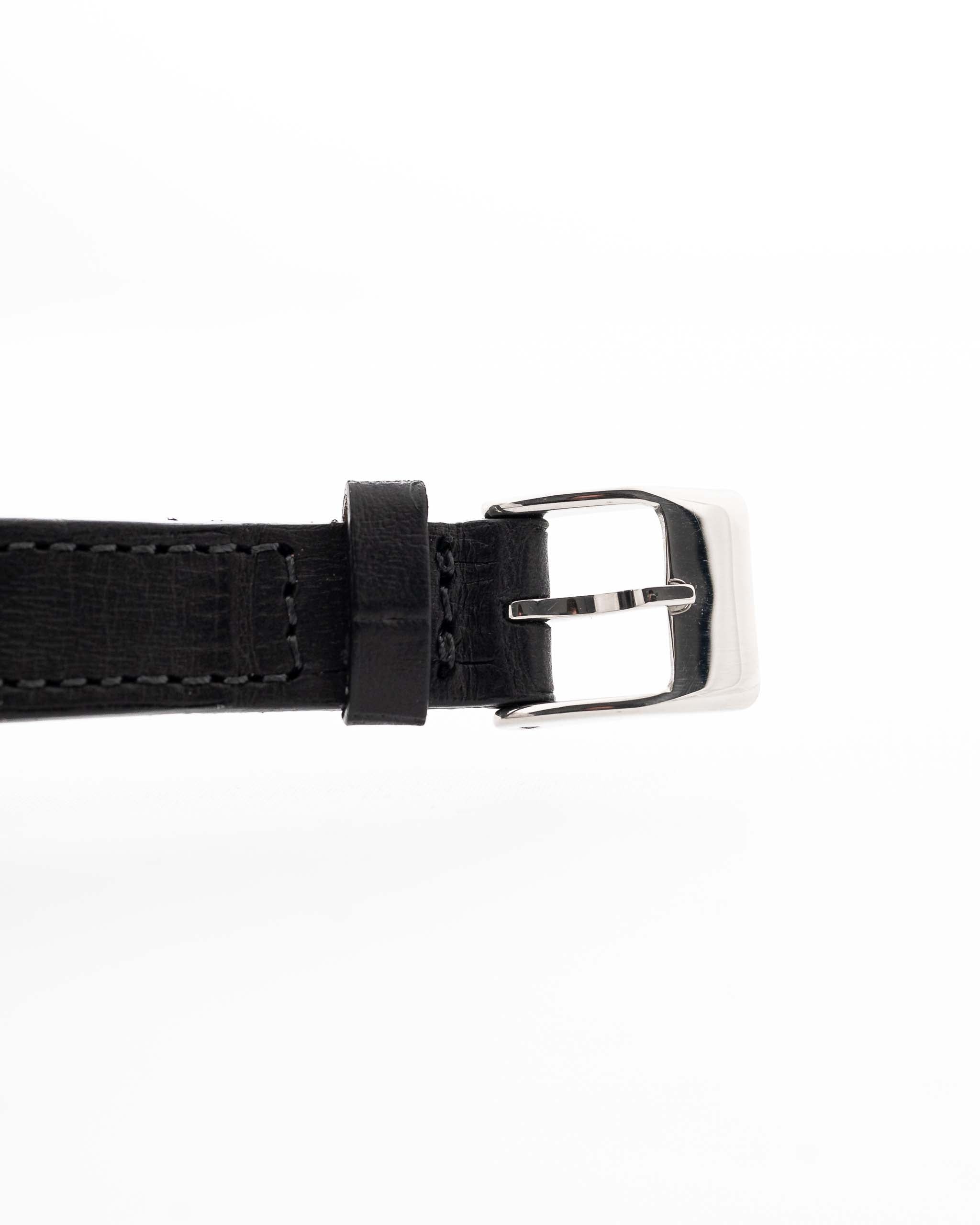 Closeup of a Vintage Piaget Altiplano 9025 Leather Strap with Diamond 18k Grey from 1990s. 33mm in 18k white gold with Manual wind movement, Dark grey sunburst dial, Diamond hour markers and black Leather strap.