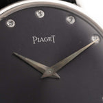 Closeup of a Vintage Piaget Altiplano 9025 Dial with Diamond 18k Grey from 1990s. 33mm in 18k white gold with Manual wind movement, Dark grey sunburst dial, Diamond hour markers and black Leather strap.