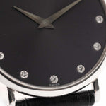 Closeup of a Vintage Piaget Altiplano 9025 Dial with Diamond 18k Grey from 1990s. 33mm in 18k white gold with Manual wind movement, Dark grey sunburst dial, Diamond hour markers and black Leather strap.