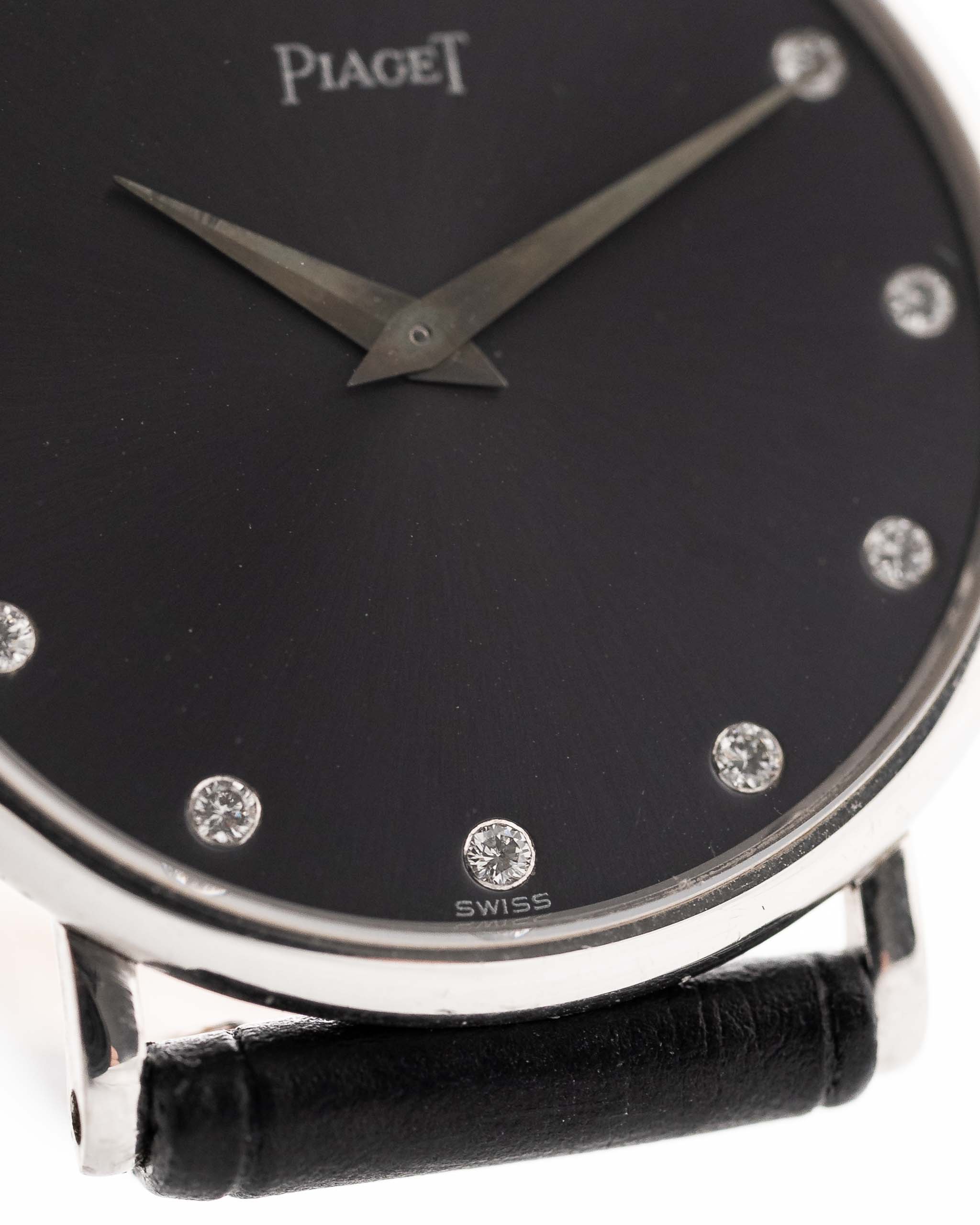 Closeup of a Vintage Piaget Altiplano 9025 Dial with Diamond 18k Grey from 1990s. 33mm in 18k white gold with Manual wind movement, Dark grey sunburst dial, Diamond hour markers and black Leather strap.