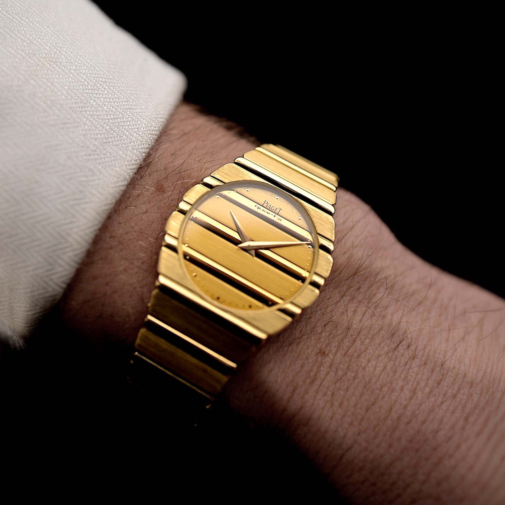 Photo of a Piaget 791 Polo from the 1980s on a wrist. 30mm case, 18k Yellow Gold, Gold Dial, Integrated 18k Gold Bracelet and Quartz Movement.
