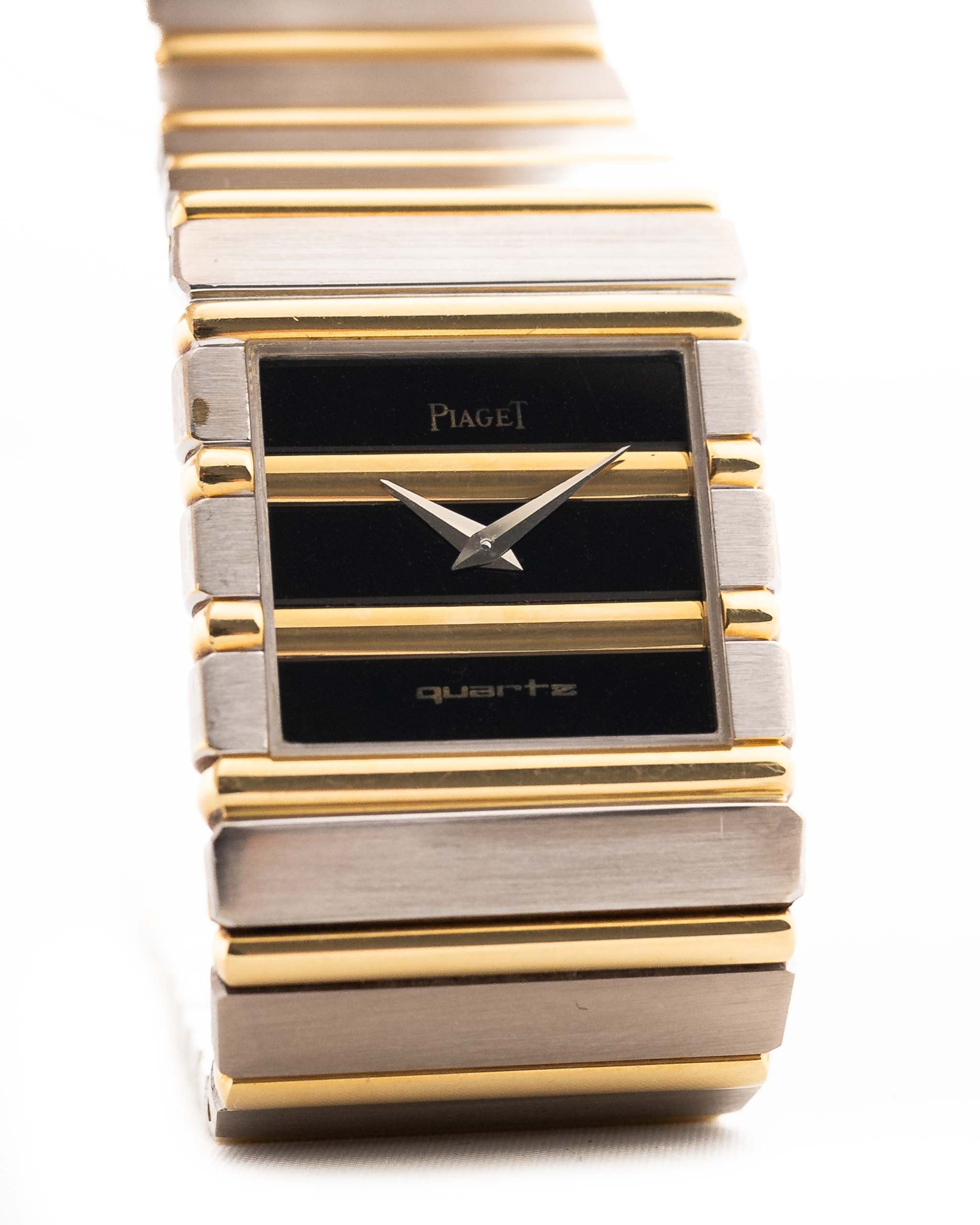 Gold Vintage Piaget Polo 7131 Onyx Zebra watch from the 1980s with a white background. 25mm wide, 18k white/yellow gold with Flawless Onyx and Zebra Dial, Gold bracelet.