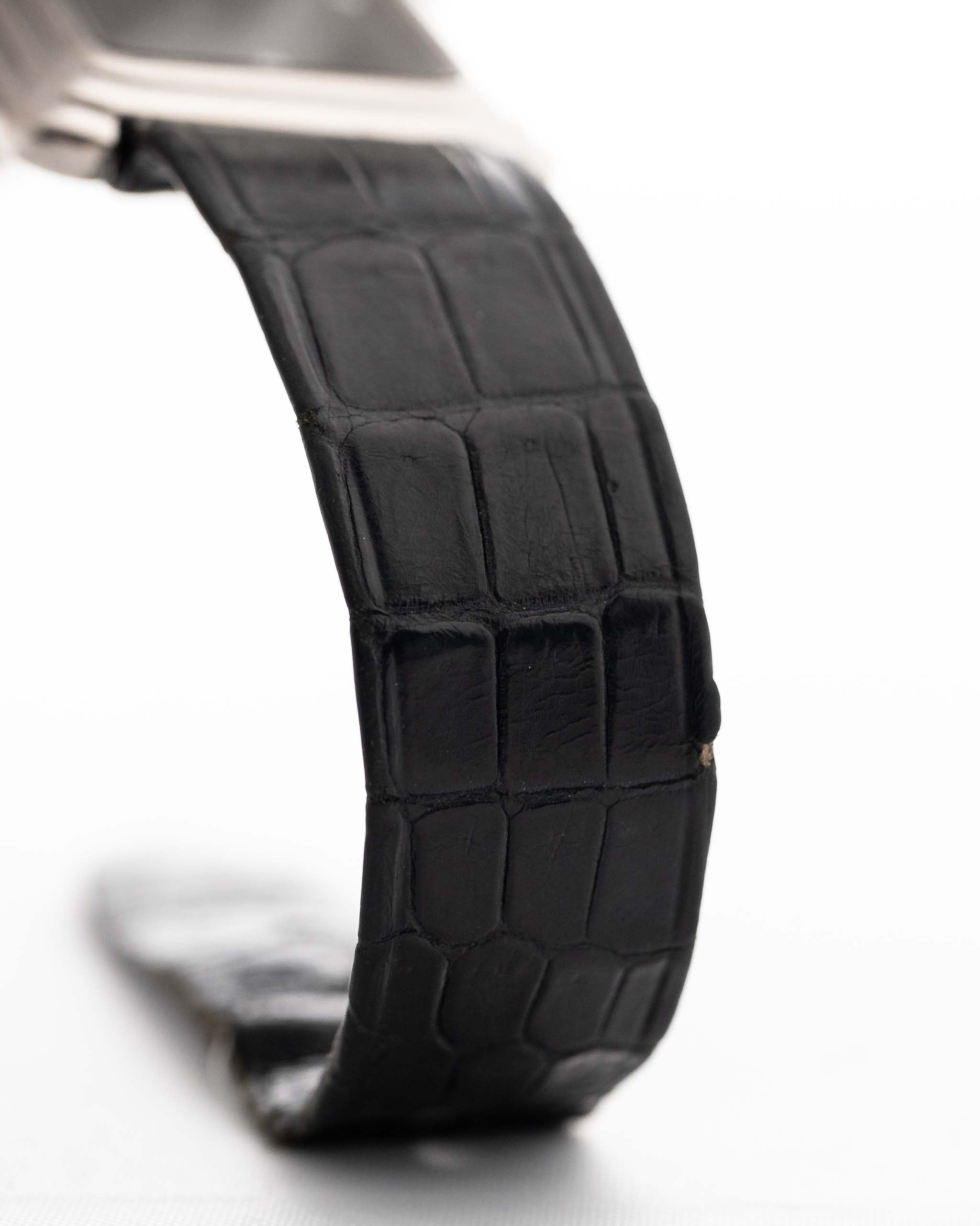 Closeup Photo of a Piaget Protocole 74101 Onyx 18k Diamond from the 1980s on a wrist. 26mm 18k White Gold Case with Onyx Dial with 4 Diamonds, Quartz Movement and Original Leather Strap.