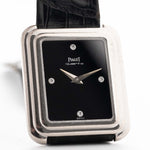 Closeup Photo of a Piaget Protocole 74101 Onyx 18k Diamond from the 1980s on a wrist. 26mm 18k White Gold Case with Onyx Dial with 4 Diamonds, Quartz Movement and Original Leather Strap.