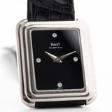 Closeup Photo of a Piaget Protocole 74101 Onyx 18k Diamond from the 1980s on a wrist. 26mm 18k White Gold Case with Onyx Dial with 4 Diamonds, Quartz Movement and Original Leather Strap.