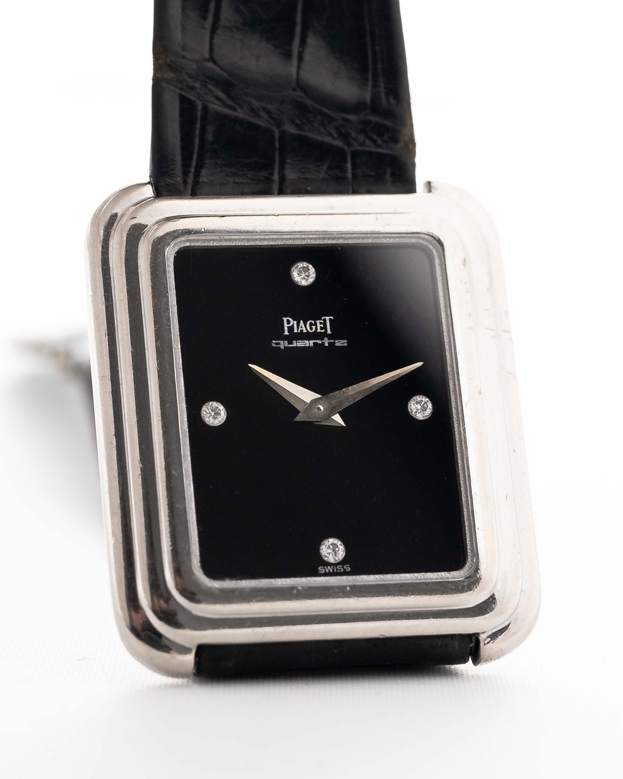 Closeup Photo of a Piaget Protocole 74101 Onyx 18k Diamond from the 1980s on a wrist. 26mm 18k White Gold Case with Onyx Dial with 4 Diamonds, Quartz Movement and Original Leather Strap.