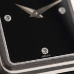 Closeup Photo of a Piaget Protocole 74101 Onyx 18k Diamond from the 1980s on a wrist. 26mm 18k White Gold Case with Onyx Dial with 4 Diamonds, Quartz Movement and Original Leather Strap.