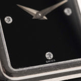 Closeup Photo of a Piaget Protocole 74101 Onyx 18k Diamond from the 1980s on a wrist. 26mm 18k White Gold Case with Onyx Dial with 4 Diamonds, Quartz Movement and Original Leather Strap.