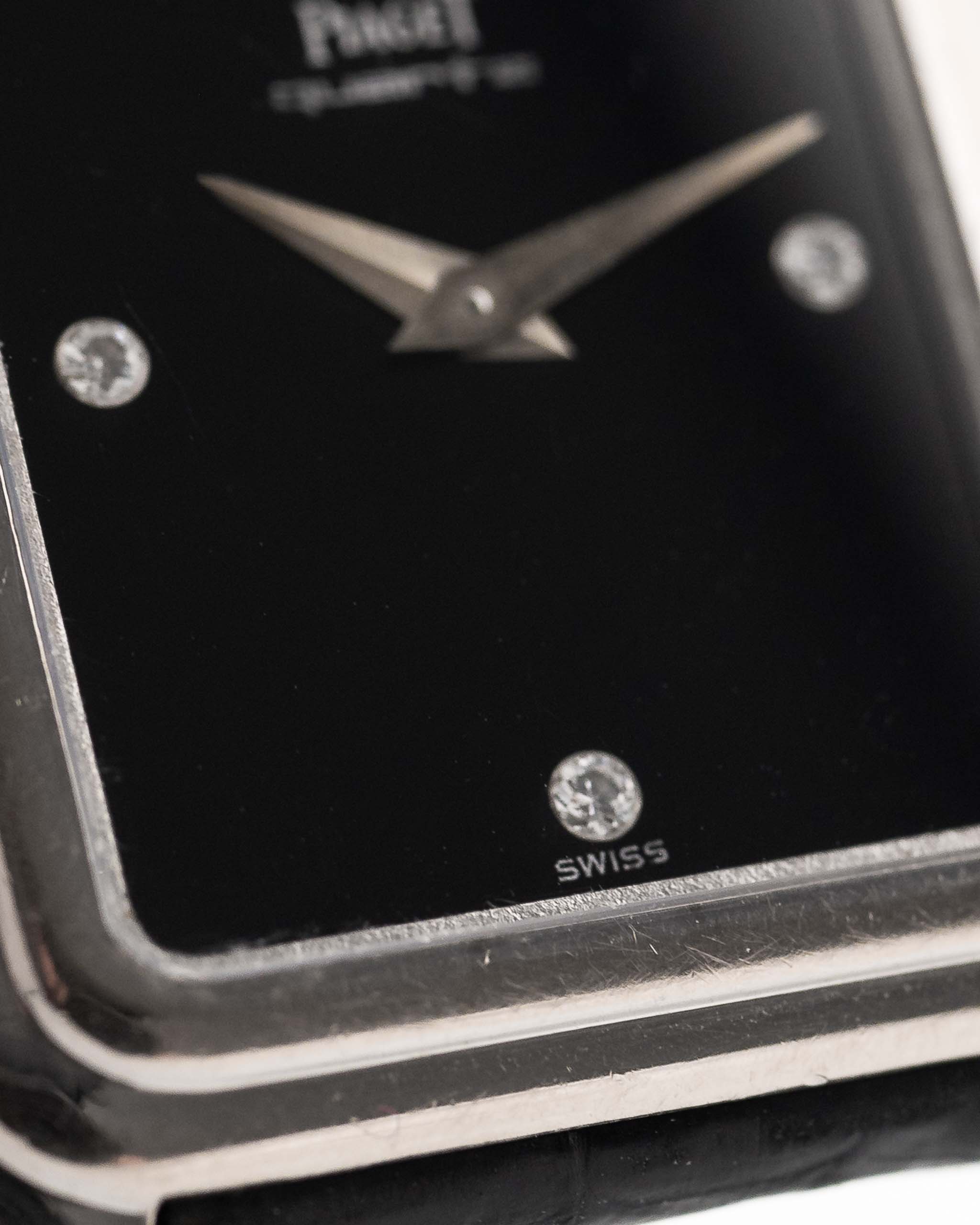 Closeup Photo of a Piaget Protocole 74101 Onyx 18k Diamond from the 1980s on a wrist. 26mm 18k White Gold Case with Onyx Dial with 4 Diamonds, Quartz Movement and Original Leather Strap.