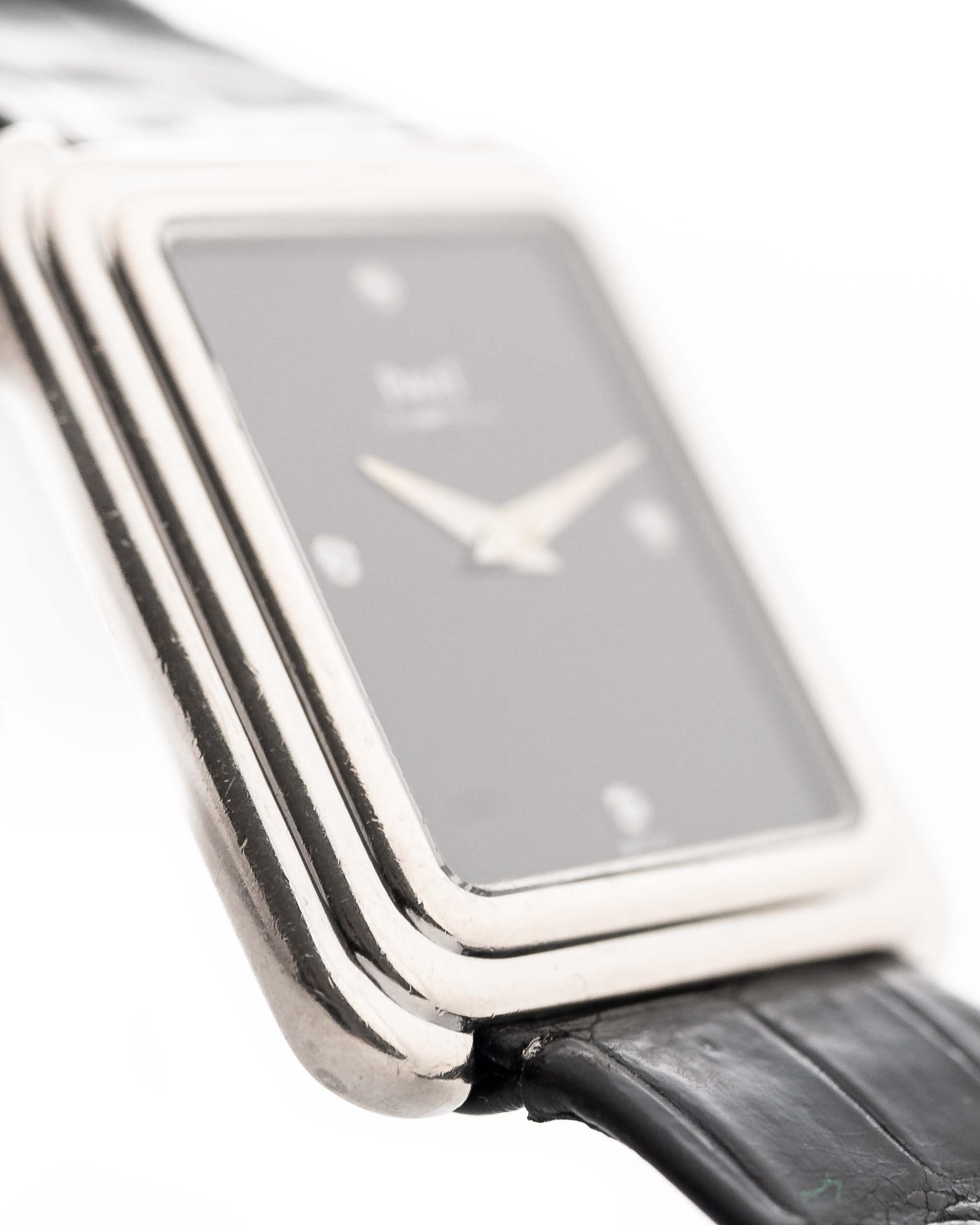 Closeup Photo of a Piaget Protocole 74101 Onyx 18k Diamond from the 1980s on a wrist. 26mm 18k White Gold Case with Onyx Dial with 4 Diamonds, Quartz Movement and Original Leather Strap.