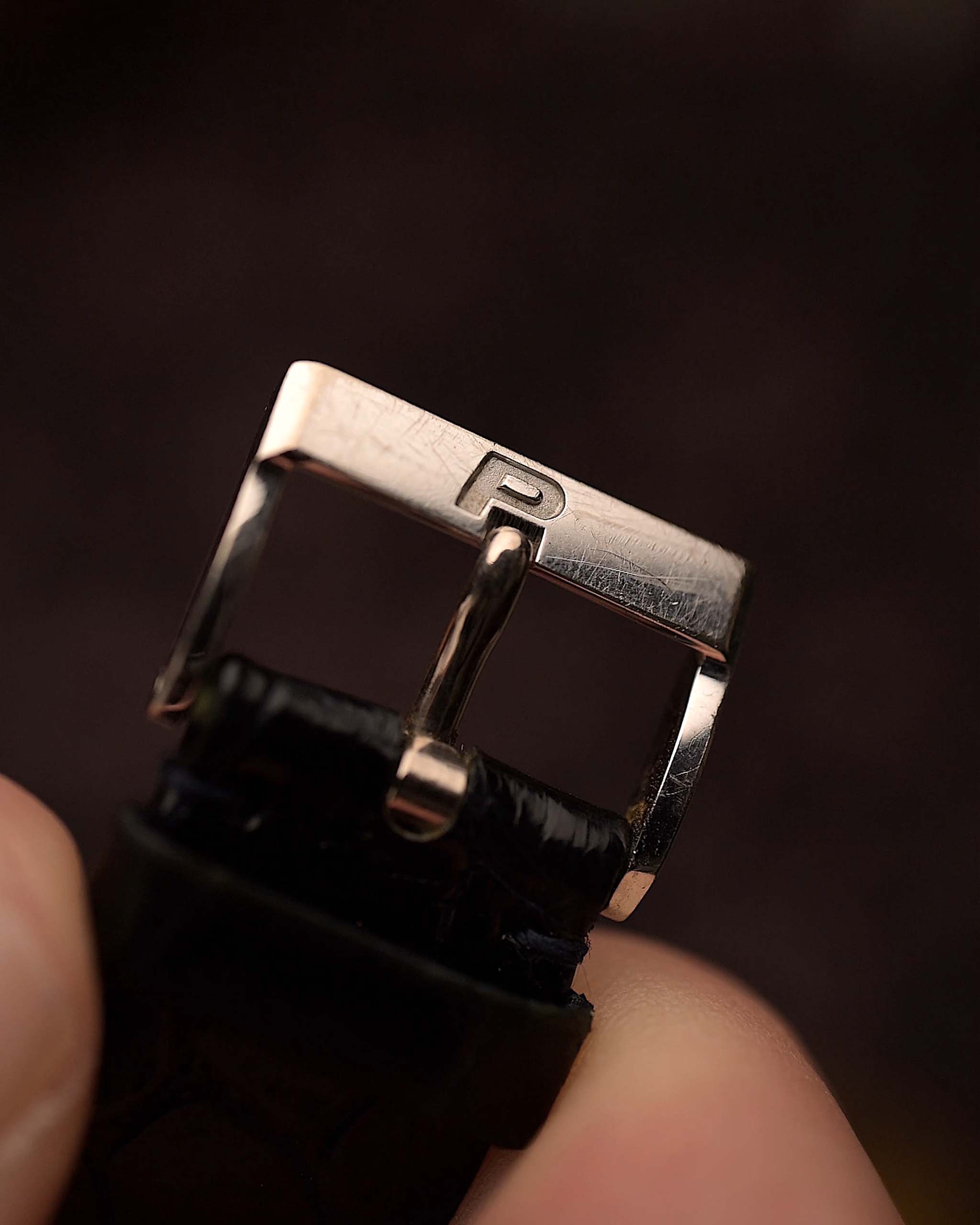 Close-up of a watch buckle of a Vintage Piaget Protocole 9151 watch, 18k white gold