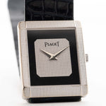 Vintage Piaget Protocole 9151 watch, 18k white gold, Onyx dial, tank shape, Caliber 9P movement, leather strap, on a wrist, white background