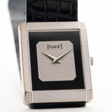 Vintage Piaget Protocole 9151 watch, 18k white gold, Onyx dial, tank shape, Caliber 9P movement, leather strap, on a wrist, white background
