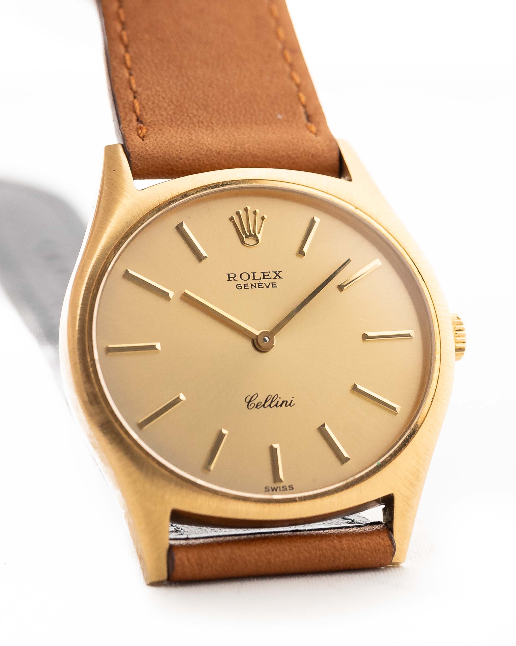A closeup photo of a vintage Rolex Cellini 3806 Ellipse 18k from 1974 on a wrist in Yellow gold. 32mm, Manual wind movement, Original golden dial and Original hands & crown with cognac brown Leather strap.